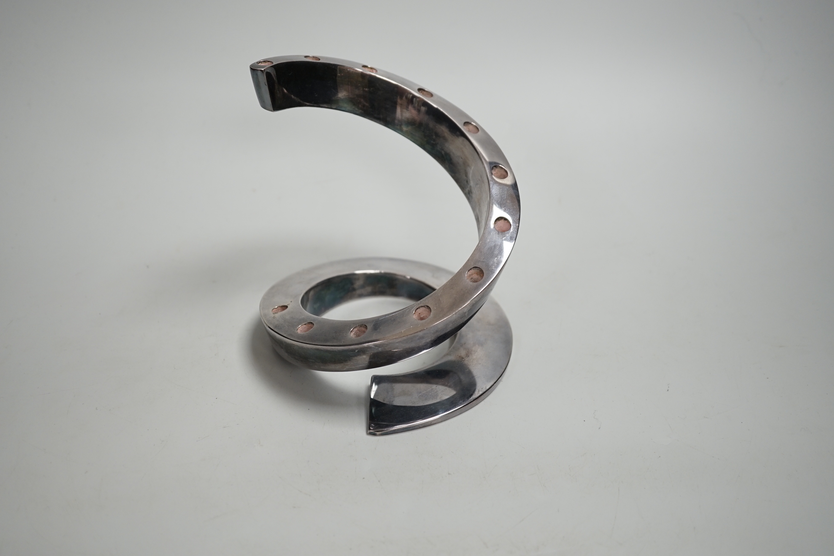 A contemporary Danish style coiled candlestick in chrome finish, stamped Dansk Designs France BV, 13.3cm high
